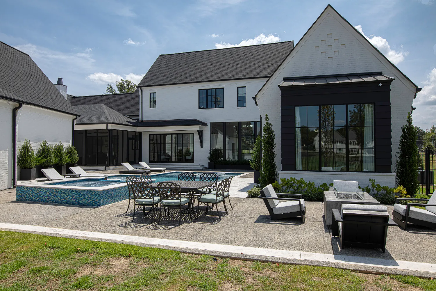 Rear exterior patio, outdoor dining and lawn of the Williamson Residence