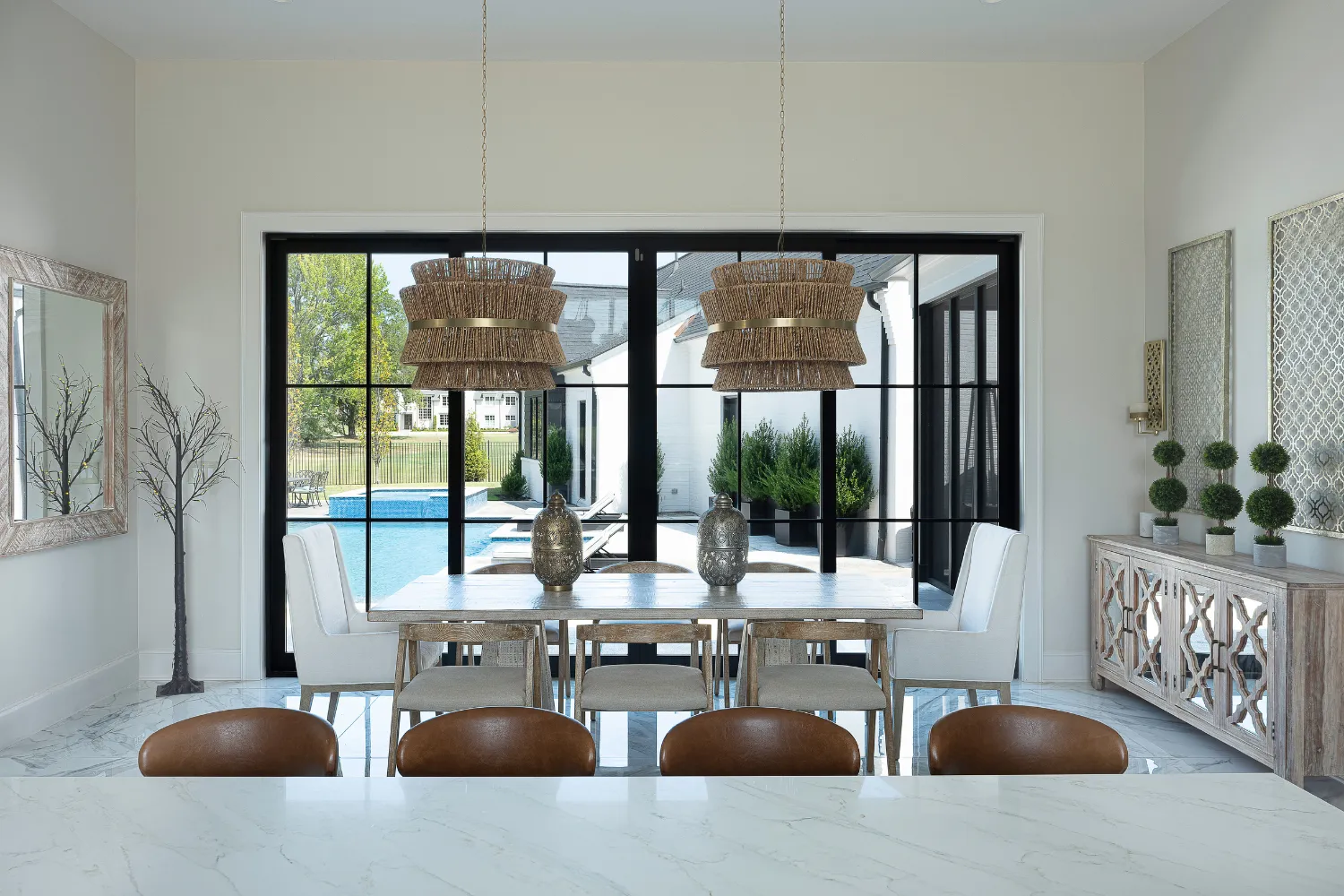 Williamson Residence dining room with large glass doors overlooking the pool