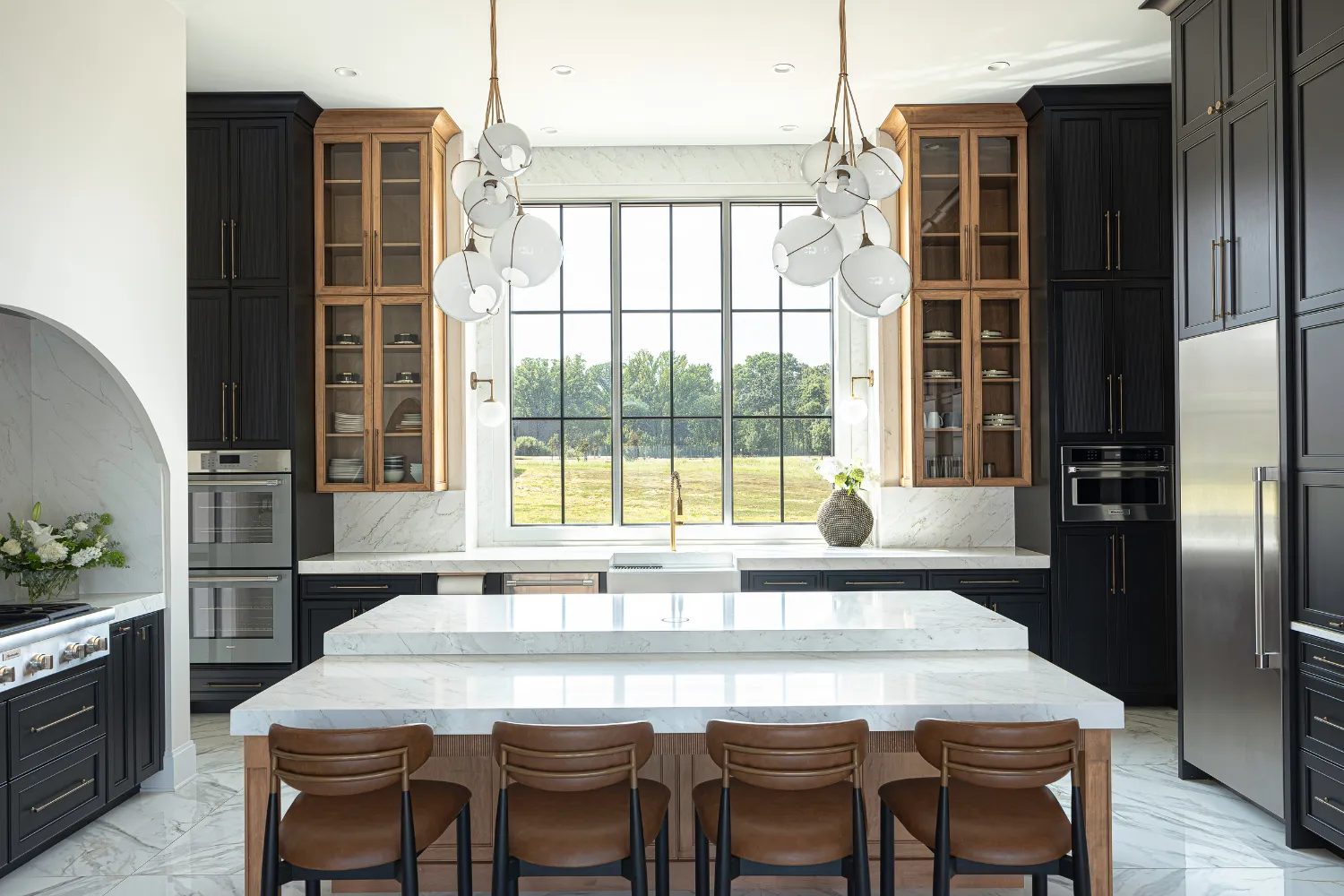 Williamson Residence kitchen island with pendant lighting and dark wood cabinetry