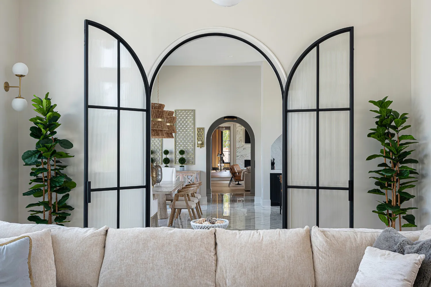 Williamson Residence living room with arched doorways and light upholstered sofa