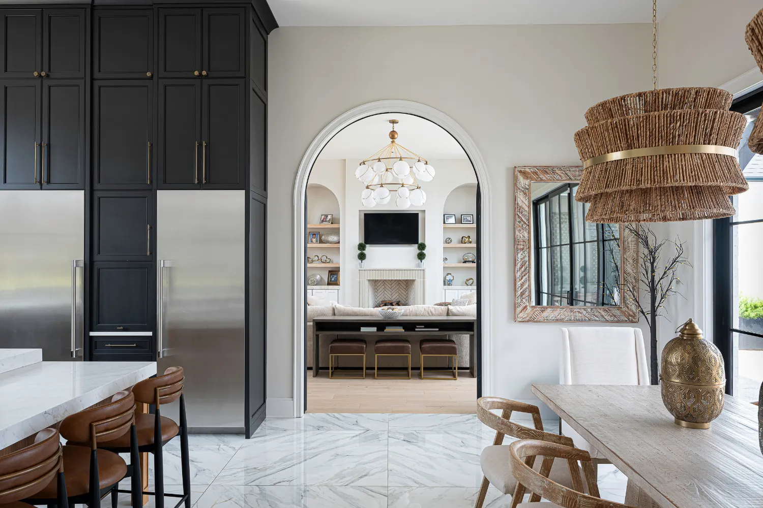 Kitchen and breakfast area with contrasting dark cabinetry at the Williamson Residence