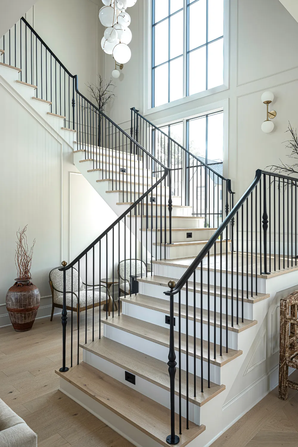 Curved interior staircase with white walls and dark handrail at the Williamson Residence