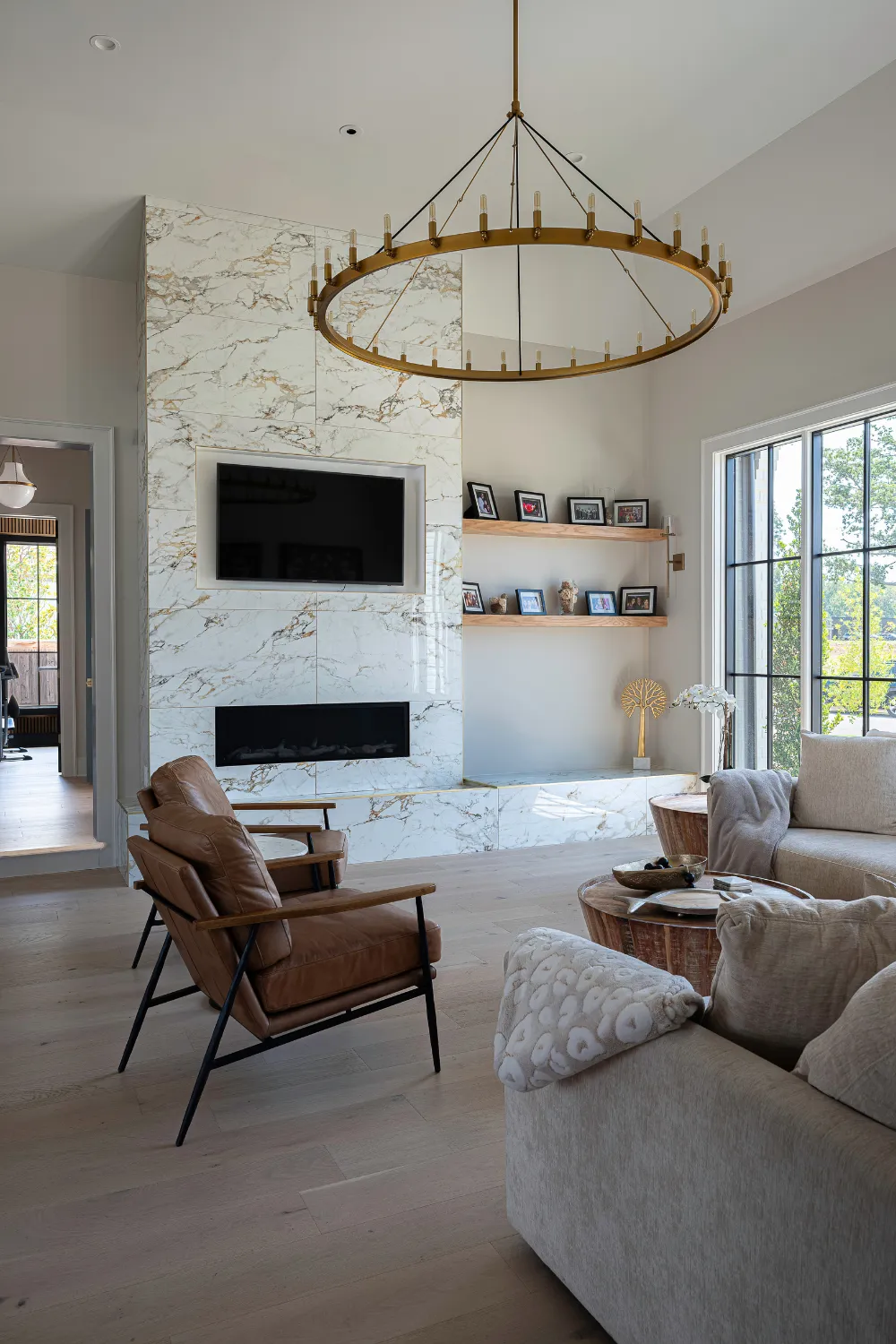 Williamson Residence great room with statement circular chandelier and fireplace