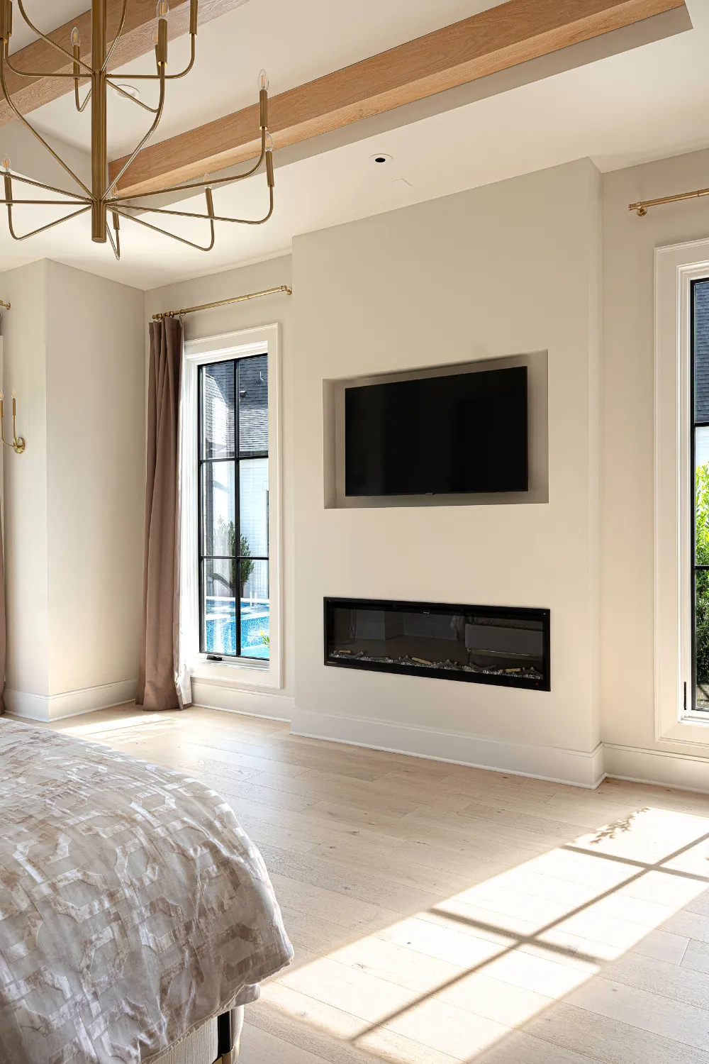 Sunlit bedroom with wall-mounted television in the Williamson Residence
