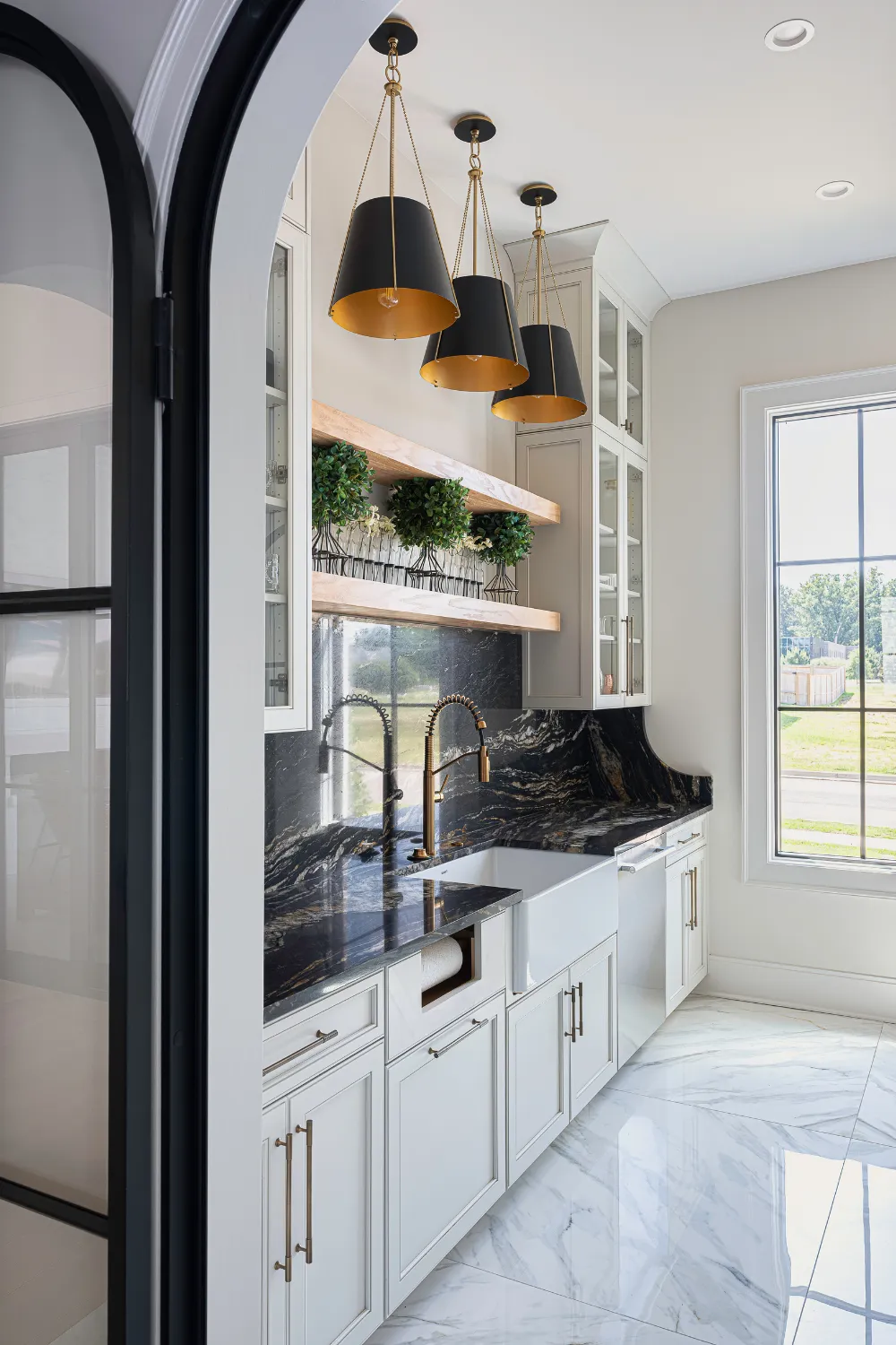 Laundry room with built-in cabinetry and glazed doors at the Williamson Residence
