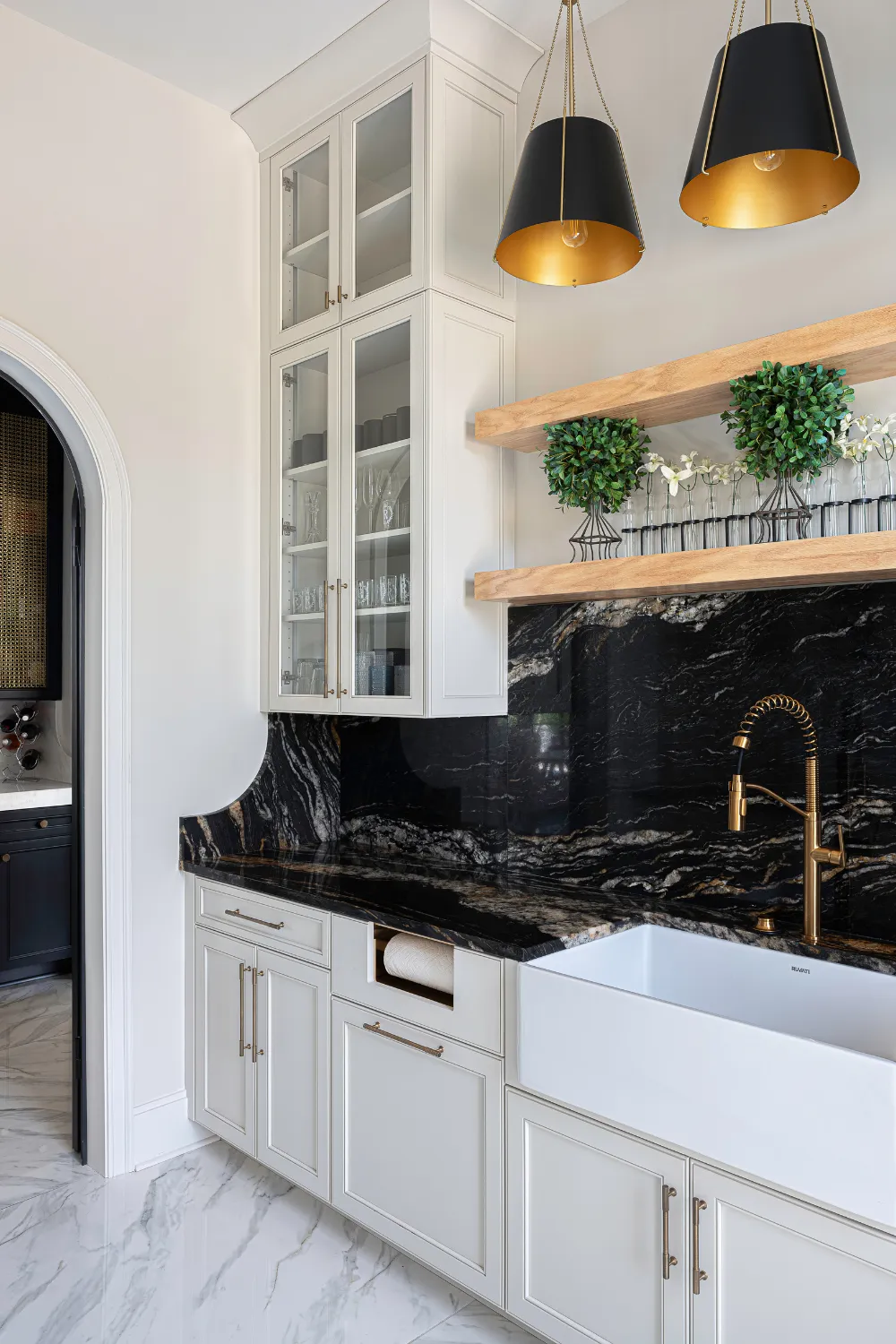 Kitchen work area with dark range hood and custom white cabinetry at the Williamson Residence