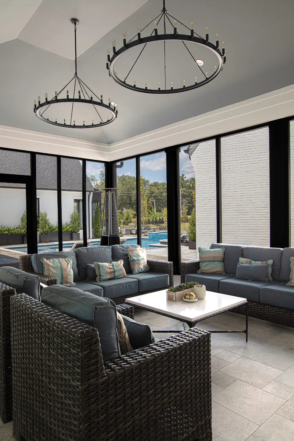 Dining and living area with glass walls opening to the terrace at the Williamson Residence