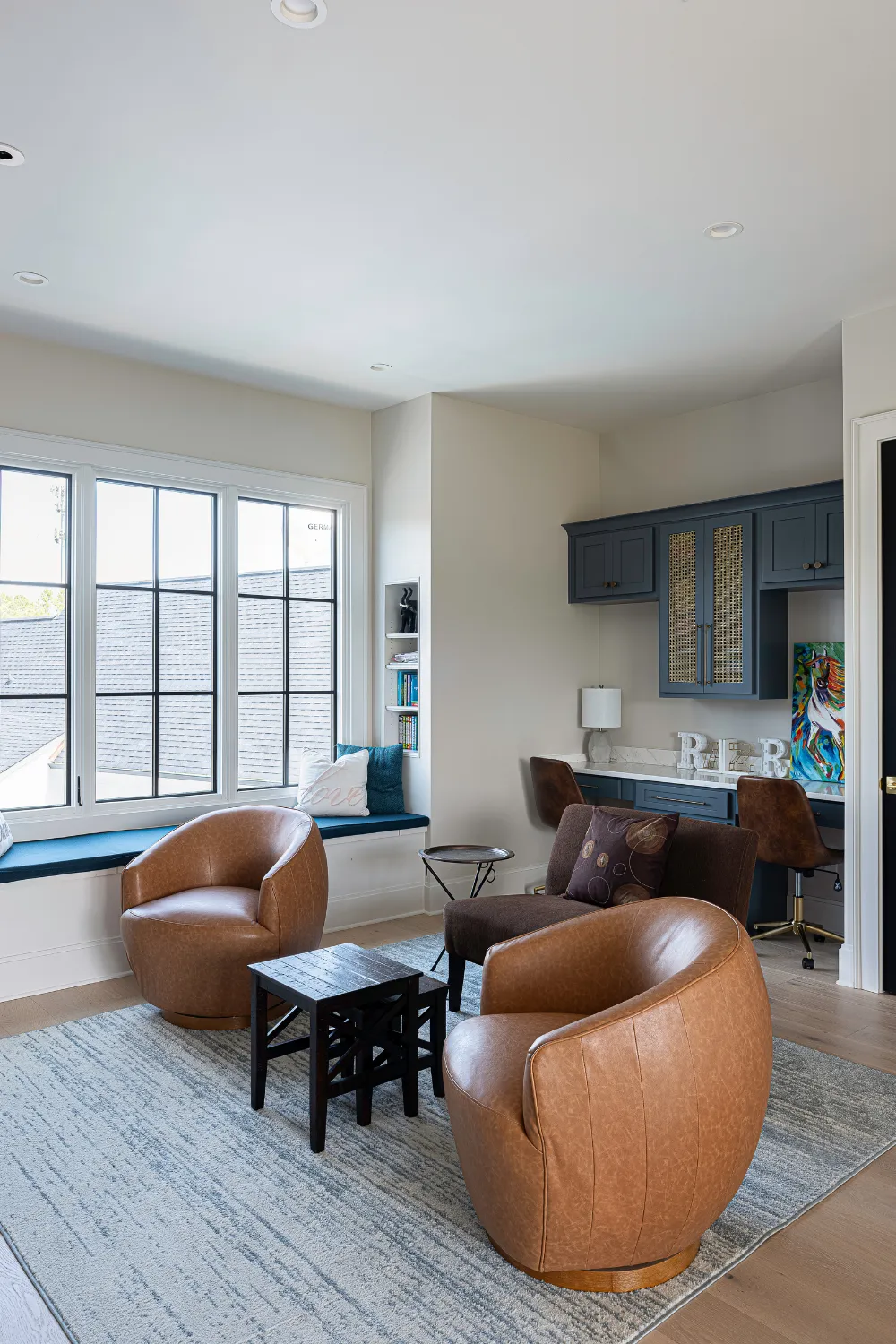 Williamson Residence sitting area with neutral upholstered chairs and garden views
